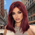 Stylish wine-red layered wig with bangs, suitable for women. Soft and easy to manage, this wine-red synthetic wig